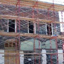 The brick was removed from the second floor windows and will be replaced with real windows at a later date.