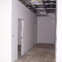 The interior walls are completed, primed and ready to paint. This is a view of the hallway between the catering kitchen and the bathrooms