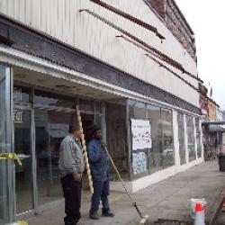 Employees from Ronald Nye Construction clean up after removing the old awning. (January 17, 2008)
